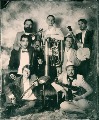 Sechs Männer im Anzug mit Musikinstrukementen