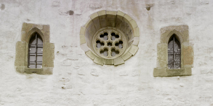 A part of the west facade of the Old Synagogue with two lancet windows and one large rose window