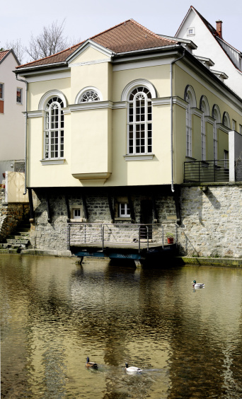 Facade of the Small Synagogue facing the river. Large, narrow windows with round arch.
