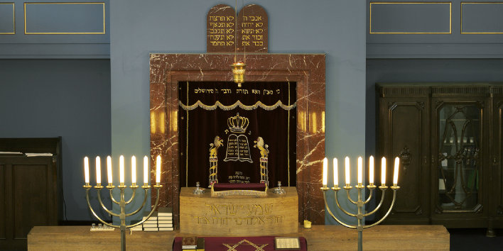 Torah shrine in the New Synagogue with plate of the Ten Commandments in Hebrew and two seven-branched  candelabra