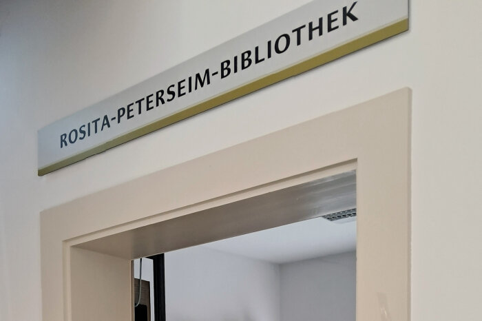 Namensschild über einem weißen Türrahmen